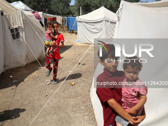 Displaced Palestinian children are playing outside their tents amid a heat wave at a temporary camp in Deir el-Balah in the central Gaza Str...