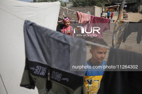 Displaced Palestinian children are playing outside their tents amid a heat wave at a temporary camp in Deir el-Balah in the central Gaza Str...