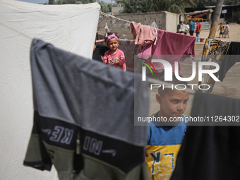 Displaced Palestinian children are playing outside their tents amid a heat wave at a temporary camp in Deir el-Balah in the central Gaza Str...