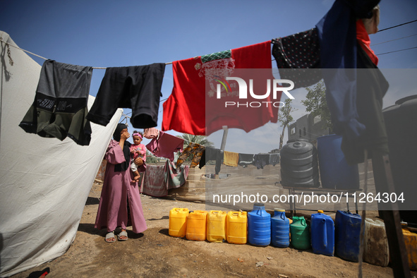 Displaced Palestinian children are playing outside their tents amid a heat wave at a temporary camp in Deir el-Balah in the central Gaza Str...