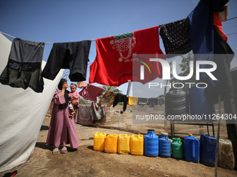 Displaced Palestinian children are playing outside their tents amid a heat wave at a temporary camp in Deir el-Balah in the central Gaza Str...