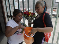 Two women are talking at the entrance to the property known as El Yuguelito, an irregular piece of land located in Colonia Polvorilla in the...