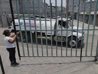 A woman is giving access to a water pipe to the property known as El Yuguelito, an irregular piece of land located in the Polvorilla Colony...