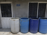 I am viewing cans to store water for homes inside the property known as El Yuguelito, an irregular piece of land located in the Polvorilla C...