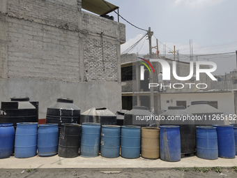 I am viewing cans to store water for homes inside the property known as El Yuguelito, an irregular piece of land located in the Polvorilla C...