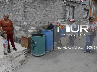 People are using boats to store water for their homes inside the property known as El Yuguelito, an irregular piece of land located in the P...