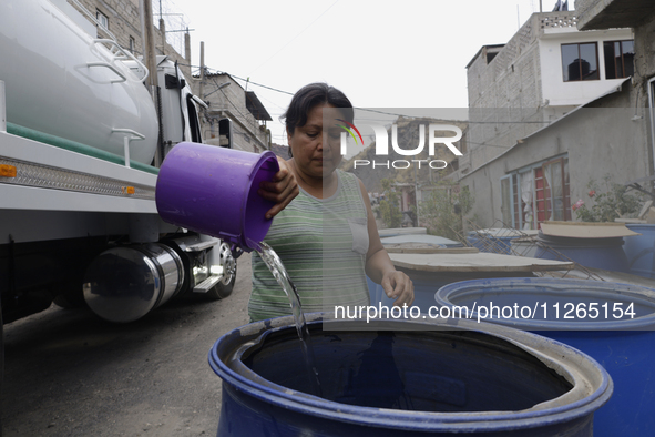 People are using boats to store water for their homes inside the property known as El Yuguelito, an irregular piece of land located in the P...