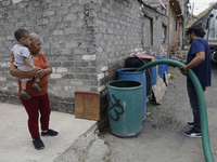 A water pipe worker is distributing water inside the property known as El Yuguelito, an irregular piece of land located in the Polvorilla Co...