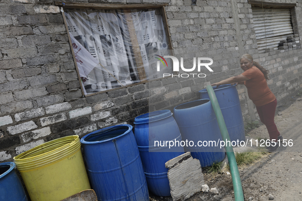 People are using boats to store water for their homes inside the property known as El Yuguelito, an irregular piece of land located in the P...