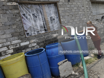 People are using boats to store water for their homes inside the property known as El Yuguelito, an irregular piece of land located in the P...