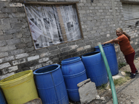 People are using boats to store water for their homes inside the property known as El Yuguelito, an irregular piece of land located in the P...