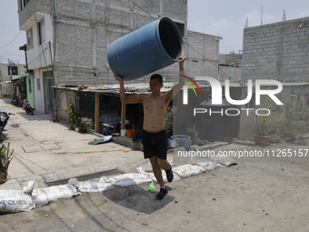 People are using boats to store water for their homes inside the property known as El Yuguelito, an irregular piece of land located in the P...