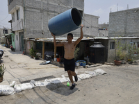 People are using boats to store water for their homes inside the property known as El Yuguelito, an irregular piece of land located in the P...