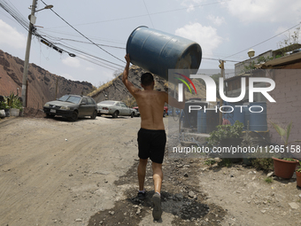 People are using boats to store water for their homes inside the property known as El Yuguelito, an irregular piece of land located in the P...