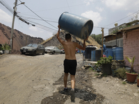 People are using boats to store water for their homes inside the property known as El Yuguelito, an irregular piece of land located in the P...