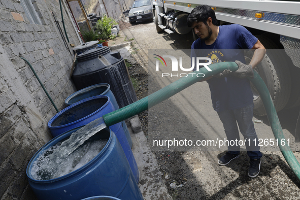 A water pipe worker is distributing water inside the property known as El Yuguelito, an irregular piece of land located in the Polvorilla Co...