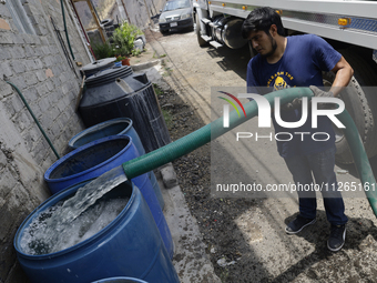 A water pipe worker is distributing water inside the property known as El Yuguelito, an irregular piece of land located in the Polvorilla Co...