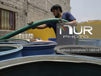 A water pipe worker is distributing water inside the property known as El Yuguelito, an irregular piece of land located in the Polvorilla Co...