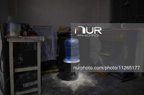 A jug is sitting inside a home on the property known as El Yuguelito, an irregular piece of land located in the Polvorilla Colony in the Izt...