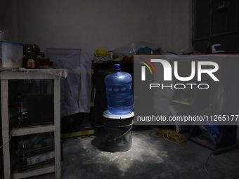 A jug is sitting inside a home on the property known as El Yuguelito, an irregular piece of land located in the Polvorilla Colony in the Izt...