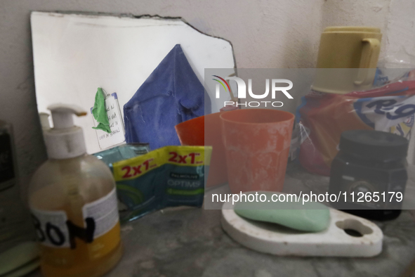 I am viewing the inside of a toilet in a home on the property known as El Yuguelito, an irregular piece of land located in the Polvorilla Co...