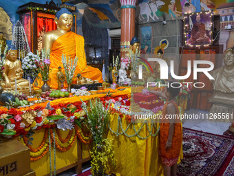 A little child is offering a lotus flower to an idol of Lord Buddha at a monastery on the occasion of Buddha Purnima in Kolkata, India, on M...