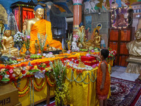 A little child is offering a lotus flower to an idol of Lord Buddha at a monastery on the occasion of Buddha Purnima in Kolkata, India, on M...