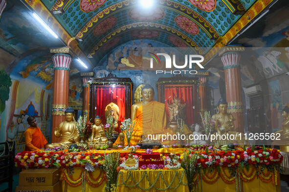 A monk is decorating a statue of Lord Buddha at a monastery on the occasion of Buddha Purnima in Kolkata, India, on May 23, 2024. Buddha Pur...