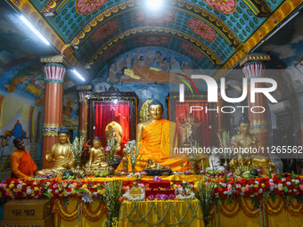 A monk is decorating a statue of Lord Buddha at a monastery on the occasion of Buddha Purnima in Kolkata, India, on May 23, 2024. Buddha Pur...