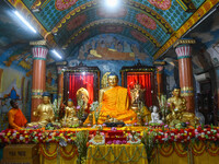 A monk is decorating a statue of Lord Buddha at a monastery on the occasion of Buddha Purnima in Kolkata, India, on May 23, 2024. Buddha Pur...