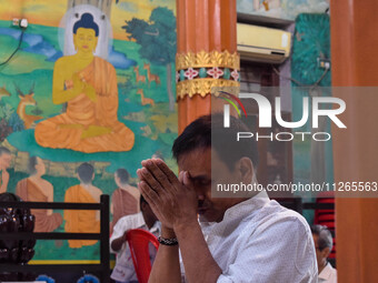 A man is praying at a monastery on the occasion of Buddha Purnima in Kolkata, India, on May 23, 2024. Buddha Purnima, or Buddha's birthday,...