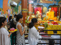 People are offering a lotus flower to an idol of Lord Buddha at a monastery on the occasion of Buddha Purnima in Kolkata, India, on May 23,...