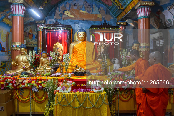 Indian Buddhist monks are decorating a statue of Lord Buddha at a monastery on the occasion of Buddha Purnima in Kolkata, India, on May 23,...