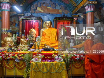 Indian Buddhist monks are decorating a statue of Lord Buddha at a monastery on the occasion of Buddha Purnima in Kolkata, India, on May 23,...