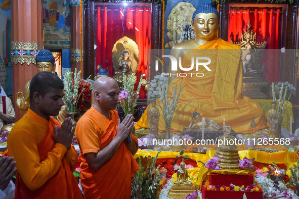 Indian Buddhist monks are offering prayers in front of a statue of Gautam Buddha at a monastery in Kolkata, India, on May 23, 2024. Buddha P...