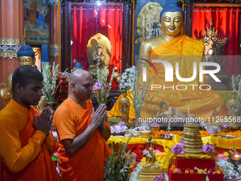 Indian Buddhist monks are offering prayers in front of a statue of Gautam Buddha at a monastery in Kolkata, India, on May 23, 2024. Buddha P...