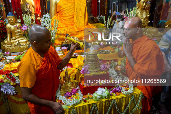 Indian Buddhist monks are offering prayers to a relic of Gautam Buddha, which contains remains of Buddha, at a monastery in Kolkata, India,...