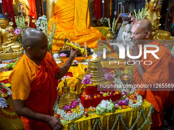 Indian Buddhist monks are offering prayers to a relic of Gautam Buddha, which contains remains of Buddha, at a monastery in Kolkata, India,...