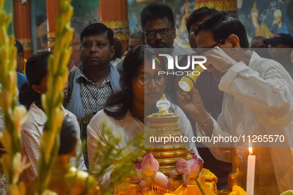 People are offering prayers to a relic of Gautam Buddha, which contains the remains of Buddha, at a monastery in Kolkata, India, on May 23,...