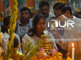 People are offering prayers to a relic of Gautam Buddha, which contains the remains of Buddha, at a monastery in Kolkata, India, on May 23,...