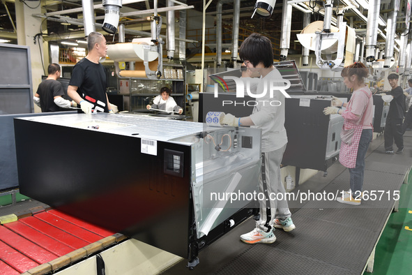 Workers are assembling refrigerators at the LG Refrigerator production base in Taizhou, China, on May 23, 2024. This is LG's largest refrige...