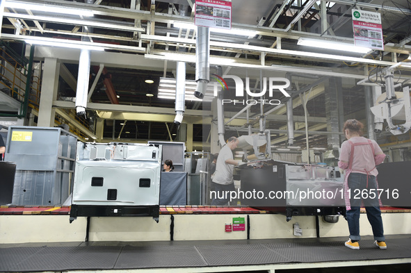 Workers are assembling refrigerators at the LG Refrigerator production base in Taizhou, China, on May 23, 2024. This is LG's largest refrige...