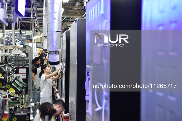 Workers are assembling refrigerators at the LG Refrigerator production base in Taizhou, China, on May 23, 2024. This is LG's largest refrige...