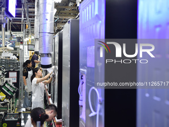 Workers are assembling refrigerators at the LG Refrigerator production base in Taizhou, China, on May 23, 2024. This is LG's largest refrige...