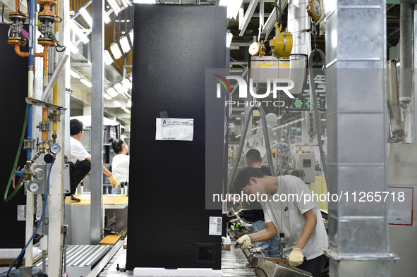 Workers are assembling refrigerators at the LG Refrigerator production base in Taizhou, China, on May 23, 2024. This is LG's largest refrige...