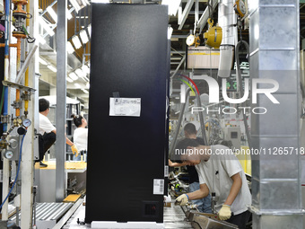 Workers are assembling refrigerators at the LG Refrigerator production base in Taizhou, China, on May 23, 2024. This is LG's largest refrige...