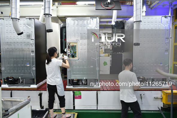 Workers are assembling refrigerators at the LG Refrigerator production base in Taizhou, China, on May 23, 2024. This is LG's largest refrige...