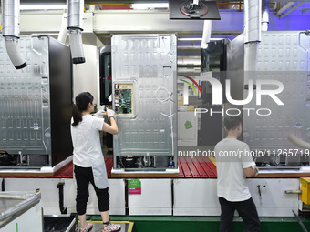 Workers are assembling refrigerators at the LG Refrigerator production base in Taizhou, China, on May 23, 2024. This is LG's largest refrige...