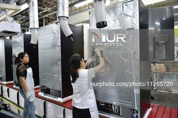 Workers are assembling refrigerators at the LG Refrigerator production base in Taizhou, China, on May 23, 2024. This is LG's largest refrige...