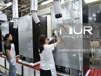 Workers are assembling refrigerators at the LG Refrigerator production base in Taizhou, China, on May 23, 2024. This is LG's largest refrige...